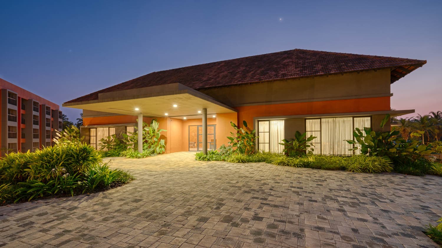 Ananta Living Dharani entrance portico at dusk